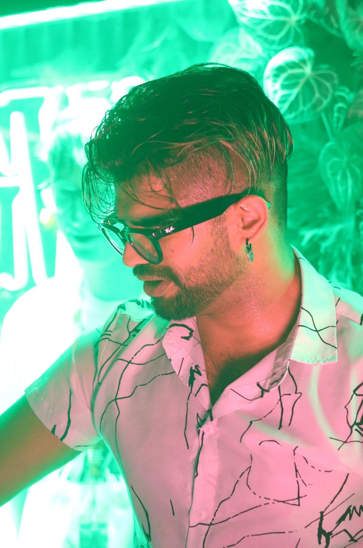 Dr Darp on the mic under green neon light at Your Shot 2024
